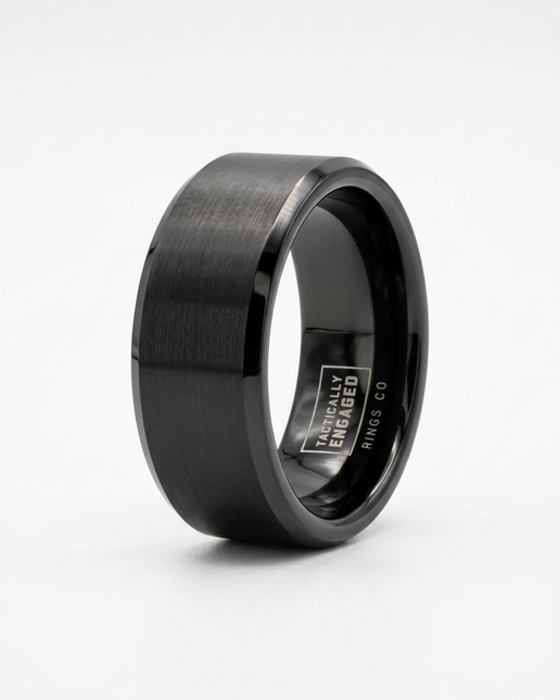 Black tungsten ring with a brushed finish on a white background