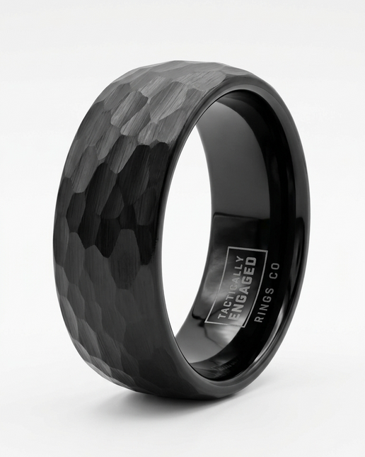 Black tungsten ring with a textured surface on a white background