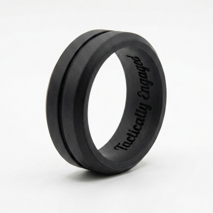 Black ring with ' tactically engaged' engraving on a white background