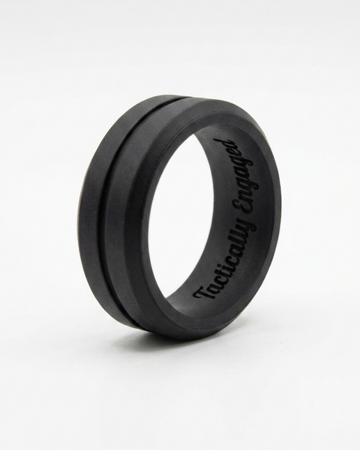 Black ring with ' tactically engaged' engraving on a white background