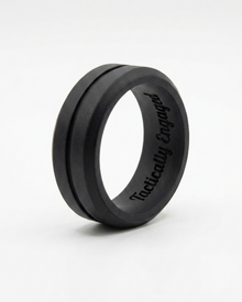 Black ring with ' tactically engaged' engraving on a white background